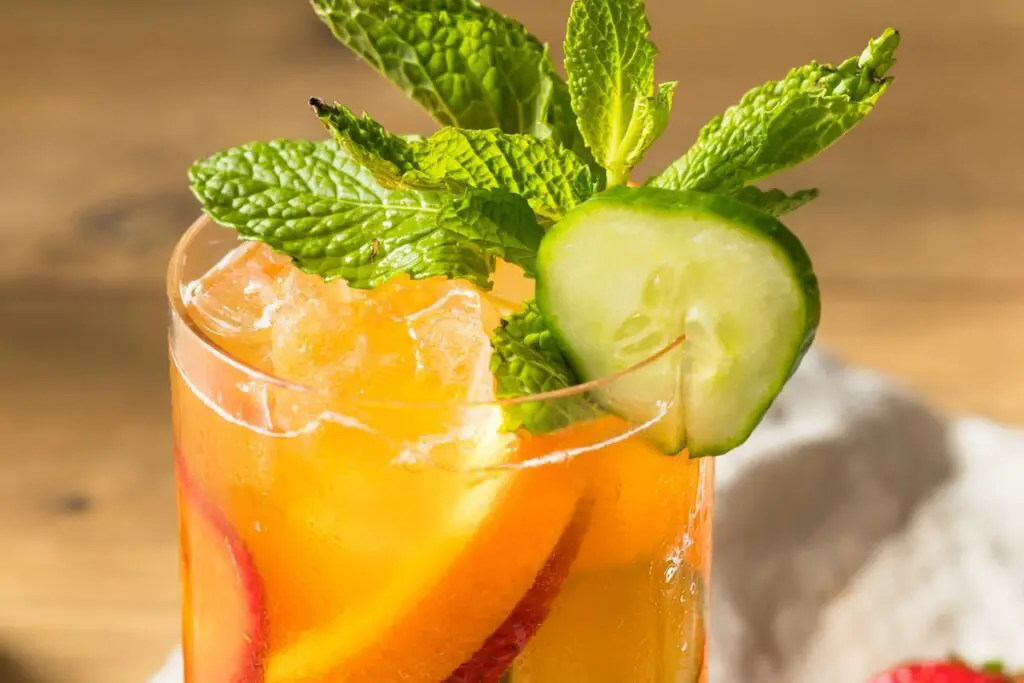 12 Crowd Pleasing Punch Recipes For Your Summer Cookout &Mdash; The Shaken Cocktail Refreshing Boozy Pimms Cup Cocktail With Gin Strawberries And Cucumber